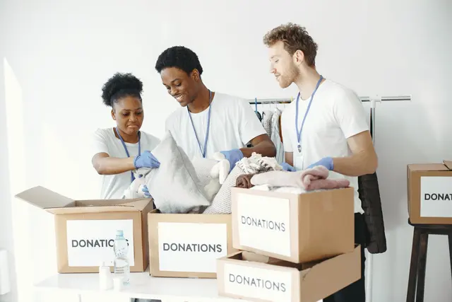 Volunteers organising boxes of donated clothing